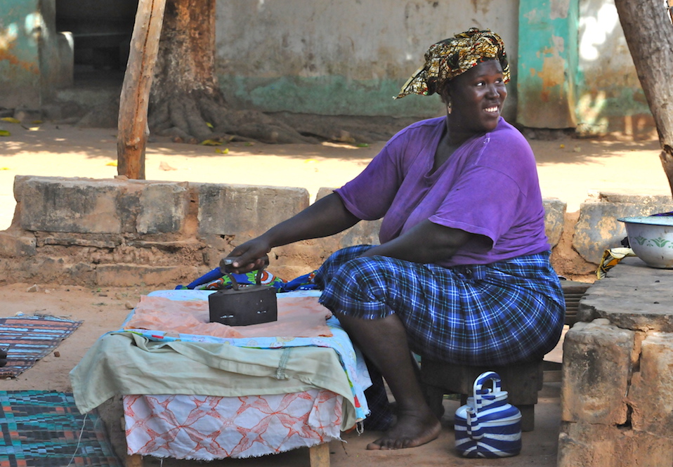 Friendly black lady, big smile, Juffureh, small Gambian village, old iron, local life, Africa